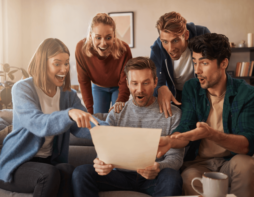 A group of friends checking out a replica diploma purchased online and admirring the print quality, raised text, gold seal, and more.